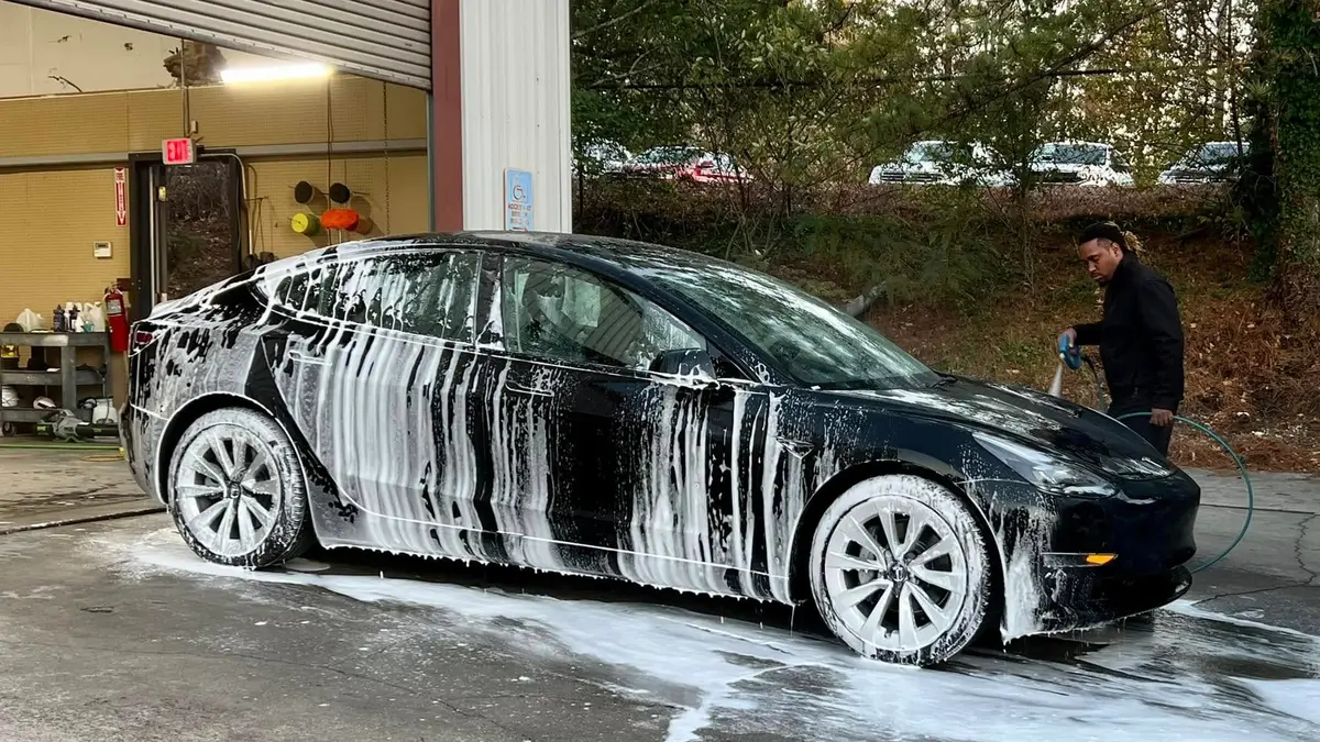Car covered in foam during a hand wash at iShop